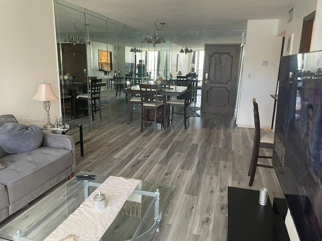 801 Three Islands Blvd Unit 112, Hallandale Beach, FL 33009 - living area featuring wood finished floors and a textured ceiling