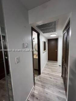 801 Three Islands Blvd Unit 112, Hallandale Beach, FL 33009 - hallway with baseboards and light wood-type flooring