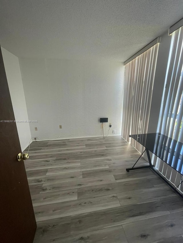 801 Three Islands Blvd Unit 112, Hallandale Beach, FL 33009 - spare room featuring wood finished floors and a textured ceiling