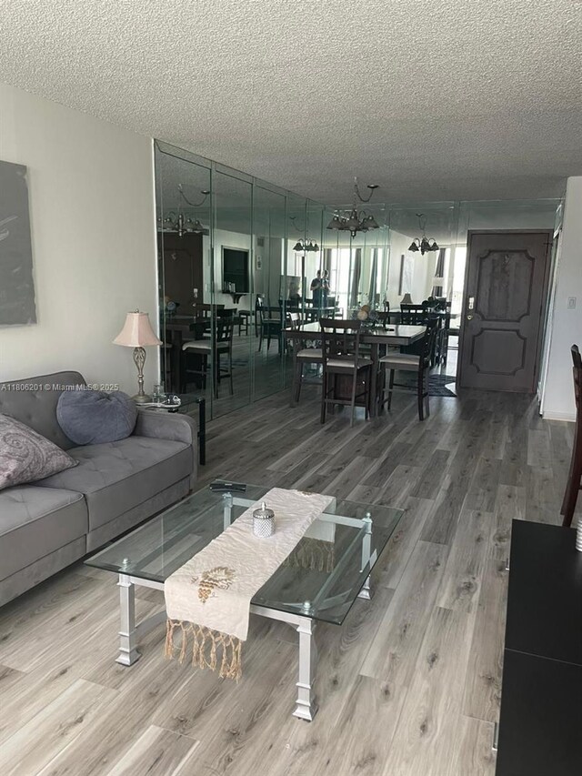 801 Three Islands Blvd Unit 112, Hallandale Beach, FL 33009 - living room with wood finished floors and a textured ceiling