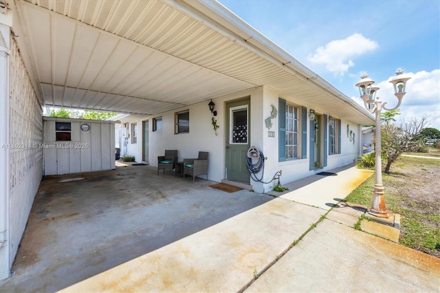 330 Lasayette Dr NE, Port Charlotte, FL 33952 - view of patio / terrace featuring an attached carport