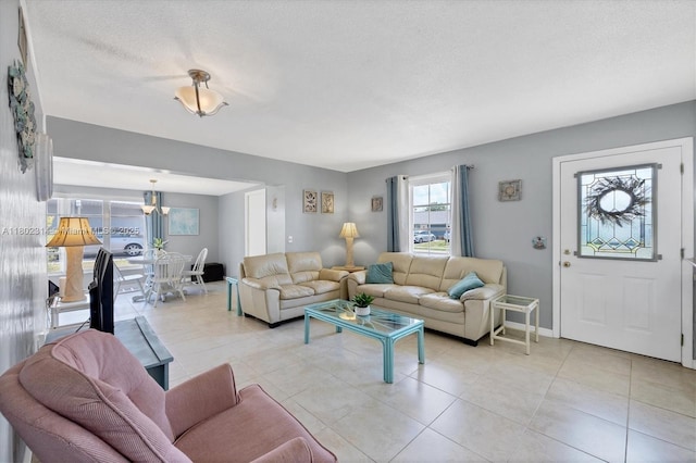 330 Lasayette Dr NE, Port Charlotte, FL 33952 - living area with light tile patterned floors, a textured ceiling, and baseboards
