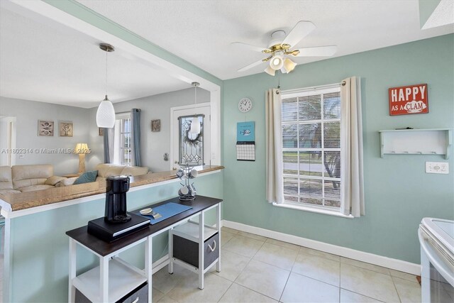 330 Lasayette Dr NE, Port Charlotte, FL 33952 - kitchen featuring white electric range oven, ceiling fan, baseboards, light tile patterned floors, and decorative light fixtures