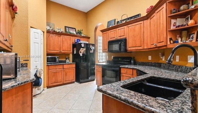 5764 NW 125th Ter, Coral Springs, FL 33076 - kitchen featuring black appliances, a sink, a high ceiling, dark stone countertops, and light tile patterned floors