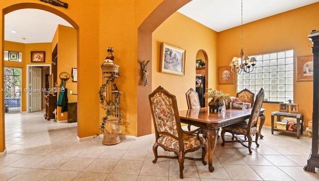 5764 NW 125th Ter, Coral Springs, FL 33076 - dining area with arched walkways, a chandelier, light tile patterned floors, a towering ceiling, and baseboards