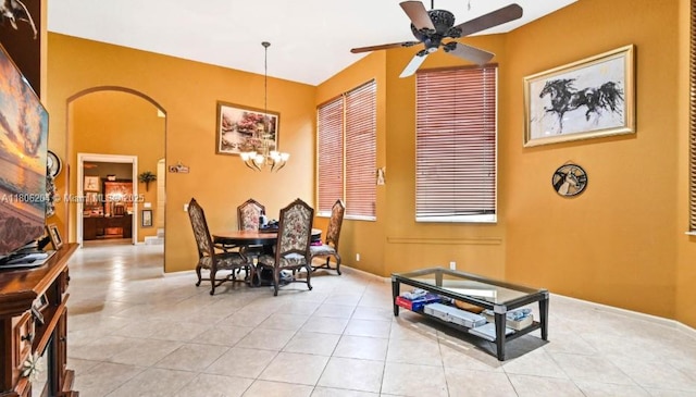 5764 NW 125th Ter, Coral Springs, FL 33076 - dining area featuring light tile patterned flooring, a chandelier, ceiling fan, and arched walkways