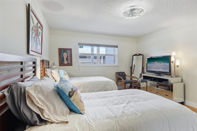 3050 NE 47th Ct Unit 205, Fort Lauderdale, FL 33308 - bedroom with a textured ceiling and wood finished floors
