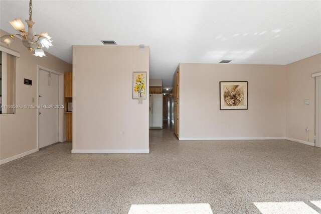 4295 SW 97th Ct, Miami, FL 33165 - spare room with speckle patterned floor, a chandelier, and baseboards