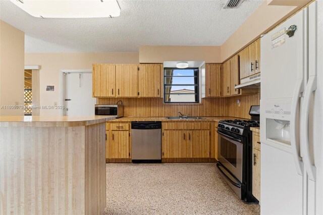 4295 SW 97th Ct, Miami, FL 33165 - kitchen with stainless steel appliances, under cabinet range hood, a sink, light countertops, and a textured ceiling