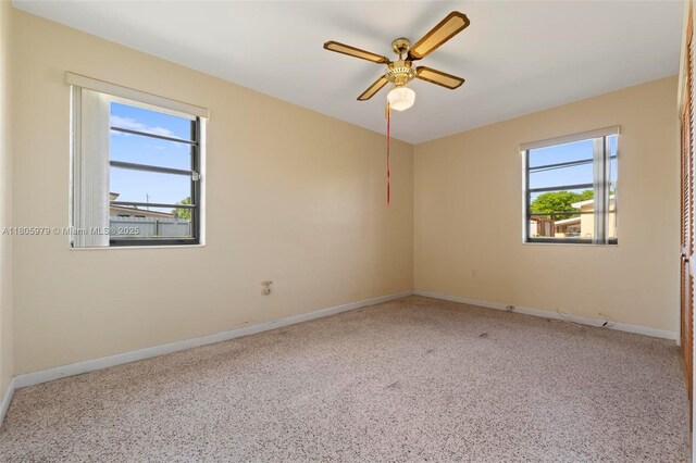 4295 SW 97th Ct, Miami, FL 33165 - empty room with plenty of natural light, a ceiling fan, baseboards, and carpet floors
