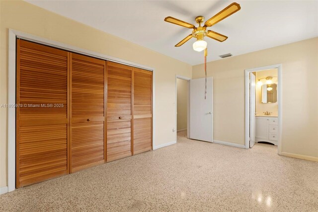 4295 SW 97th Ct, Miami, FL 33165 - unfurnished bedroom featuring a closet, speckled floor, baseboards, ceiling fan, and ensuite bath