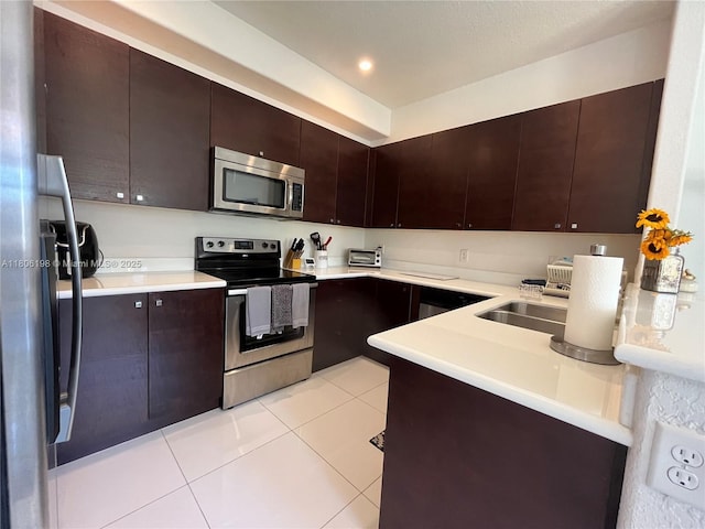 10012 NW 7th St Unit 203, Miami, FL 33172 - kitchen with appliances with stainless steel finishes, light countertops, light tile patterned floors, and dark brown cabinets