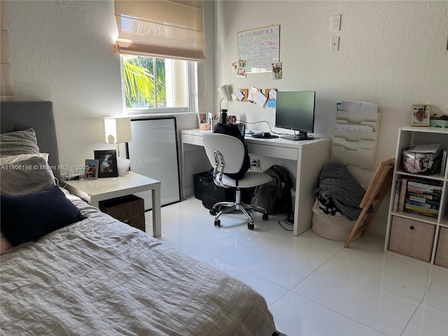 10012 NW 7th St Unit 203, Miami, FL 33172 - bedroom featuring a textured wall, an office area, light tile patterned floors, and freestanding refrigerator