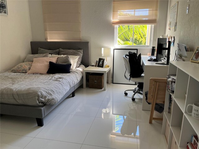 10012 NW 7th St Unit 203, Miami, FL 33172 - bedroom featuring a desk and light tile patterned floors