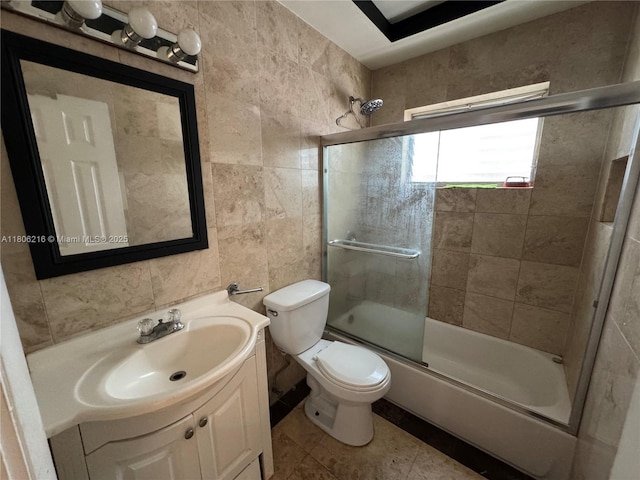 75 Washington Ave Unit 18, Miami Beach, FL 33139 - full bathroom with toilet, vanity, tile walls, bath / shower combo with glass door, and tile patterned floors