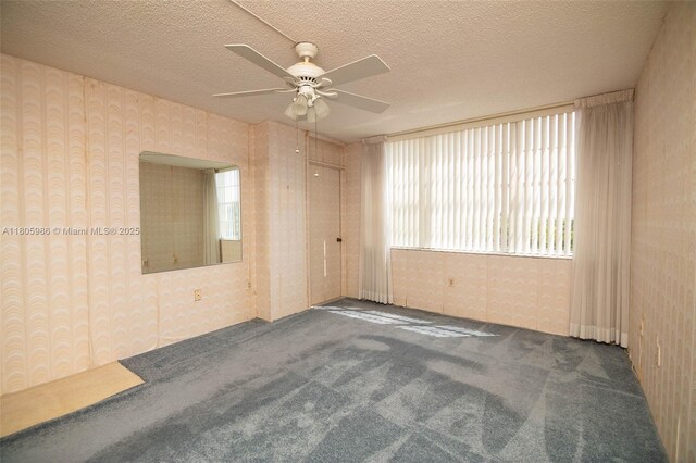 900 Saint Charles Pl Unit 616, Pembroke Pines, FL 33026 - spare room featuring a ceiling fan, carpet flooring, wallpapered walls, plenty of natural light, and a textured ceiling