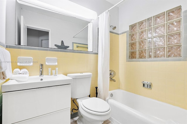 1411 NE 12th St, Fort Lauderdale, FL 33304 - bathroom featuring tile walls, toilet, shower / bathtub combination with curtain, and vanity