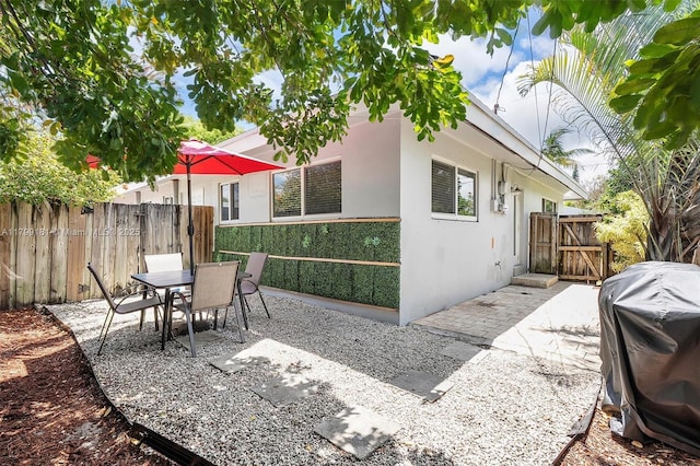 1411 NE 12th St, Fort Lauderdale, FL 33304 - view of patio featuring area for grilling, a gate, and outdoor dining area