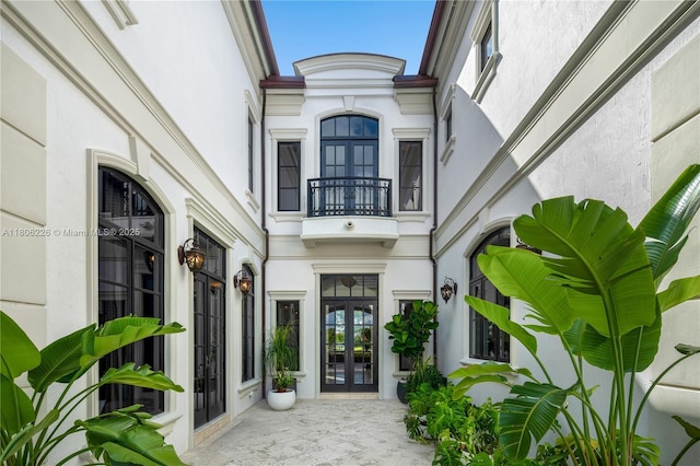 9320 Gallardo St, Coral Gables, FL 33156 - doorway to property featuring french doors, a balcony, and stucco siding