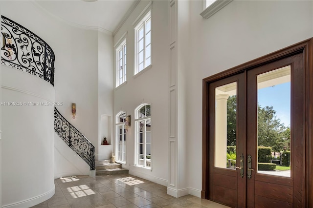 9320 Gallardo St, Coral Gables, FL 33156 - entrance foyer featuring french doors, a towering ceiling, baseboards, ornamental molding, and stairway