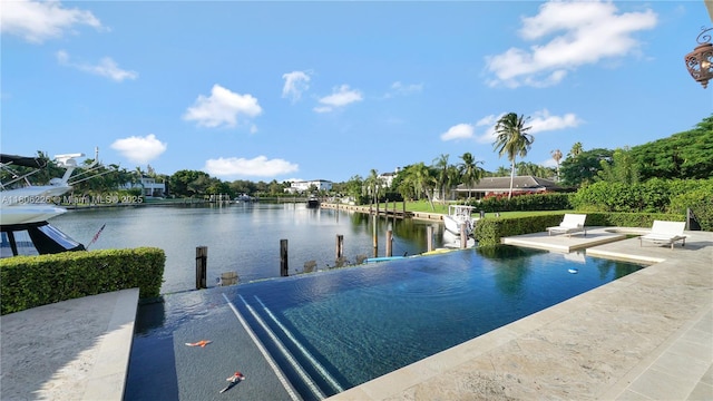 9320 Gallardo St, Coral Gables, FL 33156 - view of swimming pool with a water view, an infinity pool, a dock, and a patio area