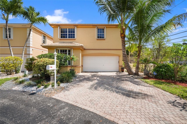 1282 Grant Ct, Hollywood, FL 33019 - mediterranean / spanish home with stucco siding, a tile roof, decorative driveway, and an attached garage