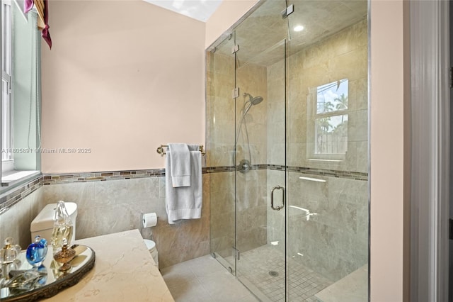 1282 Grant Ct, Hollywood, FL 33019 - bathroom with a shower stall, tile walls, a wainscoted wall, toilet, and tile patterned flooring