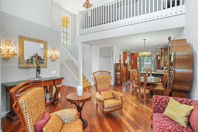 1282 Grant Ct, Hollywood, FL 33019 - living area with stairway, wood finished floors, a towering ceiling, and baseboards