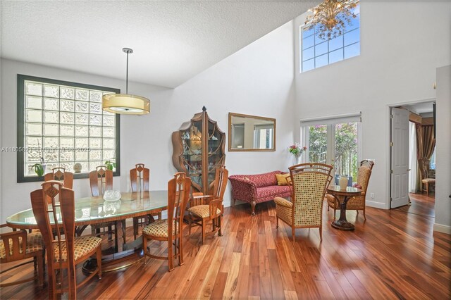 1282 Grant Ct, Hollywood, FL 33019 - dining area featuring wood finished floors, a high ceiling, and a chandelier