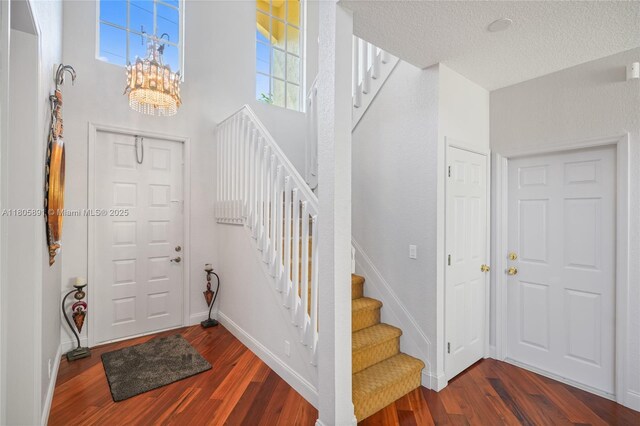 1282 Grant Ct, Hollywood, FL 33019 - entryway featuring wood finished floors, stairs, a chandelier, and a textured ceiling
