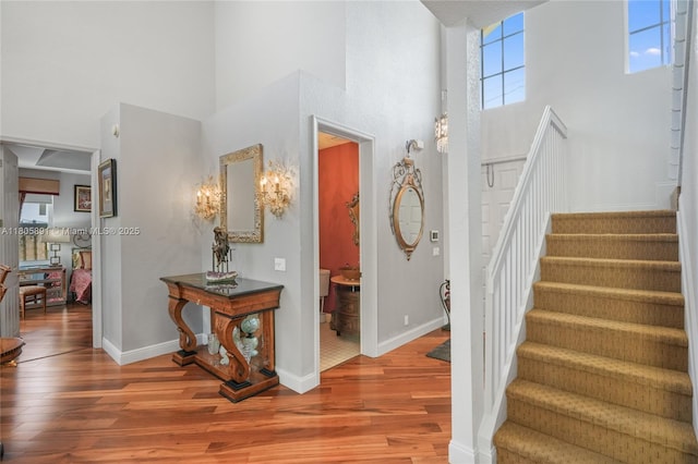 1282 Grant Ct, Hollywood, FL 33019 - stairway featuring a towering ceiling, wood finished floors, and baseboards