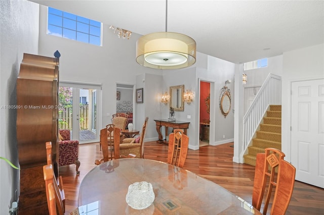 1282 Grant Ct, Hollywood, FL 33019 - dining room featuring wood finished floors, stairway, baseboards, and a towering ceiling