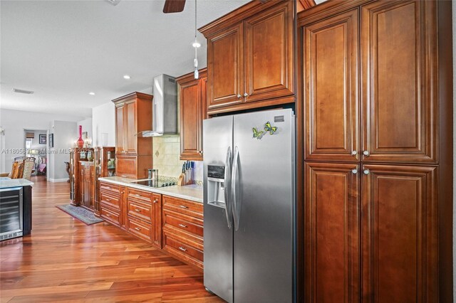 1282 Grant Ct, Hollywood, FL 33019 - kitchen with stainless steel refrigerator with ice dispenser, wall chimney exhaust hood, wine cooler, light wood finished floors, and tasteful backsplash