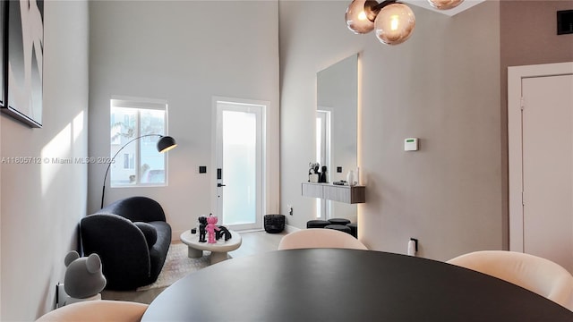 dining area featuring a towering ceiling