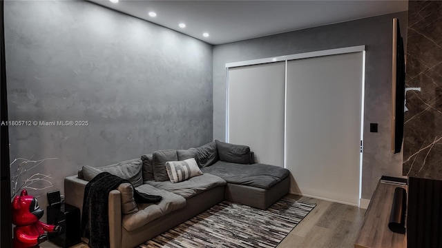 living room with wood finished floors and recessed lighting