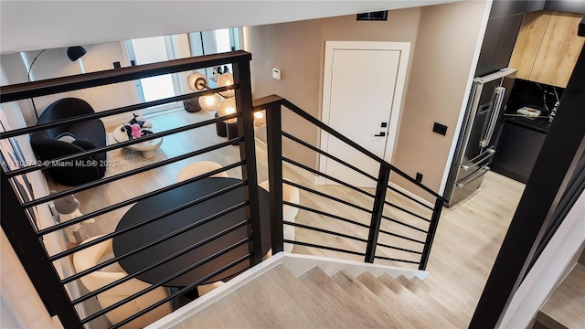 stairs featuring wood finished floors and baseboards