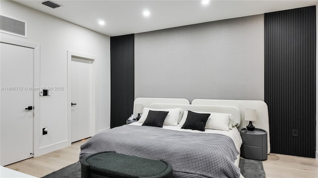 bedroom with light wood finished floors and recessed lighting