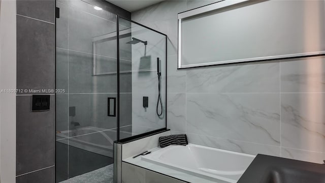 full bathroom with a shower stall and a garden tub
