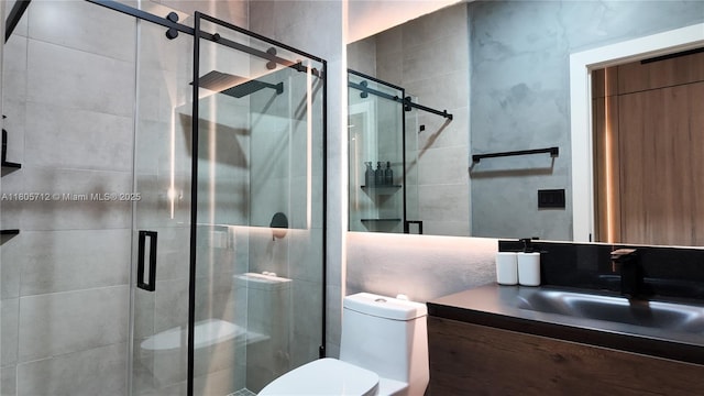 full bathroom featuring toilet, a shower stall, and vanity