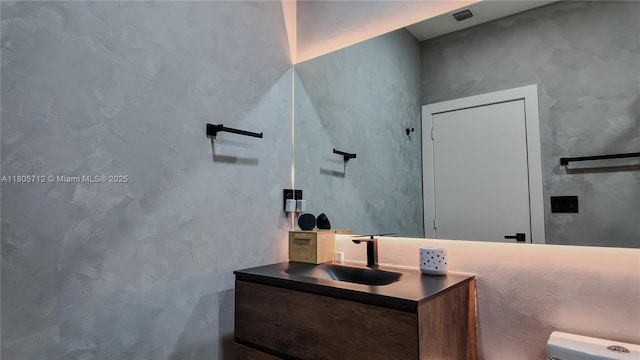 bathroom featuring vanity and toilet
