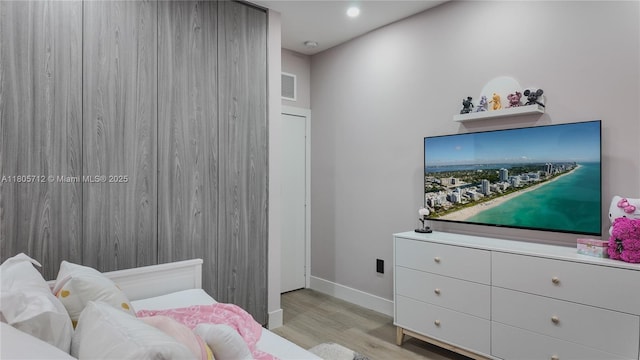 bedroom with wood finished floors, baseboards, and recessed lighting