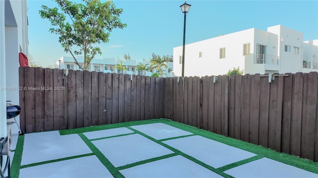 view of patio / terrace featuring fence and a residential view