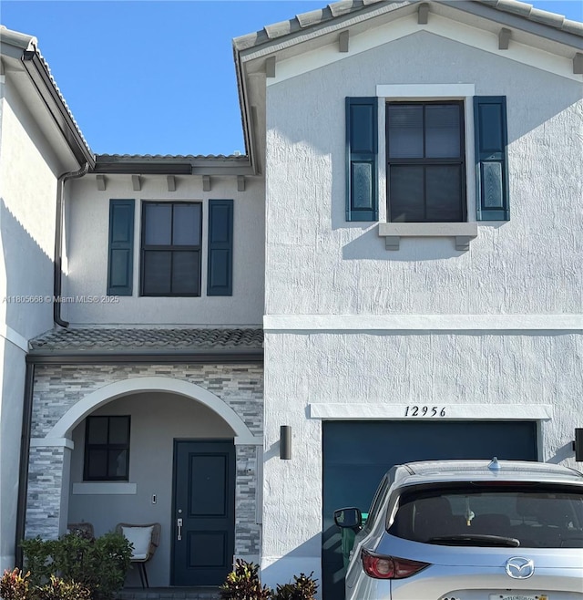 12956 SW 286th Ter, Homestead, FL 33033 - view of front of home with stone siding, stucco siding, and an attached garage
