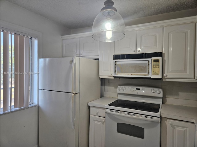 8620 N Sherman Cir Unit 202, Miramar, FL 33025 - kitchen with white appliances, white cabinets, light countertops, tasteful backsplash, and a textured ceiling