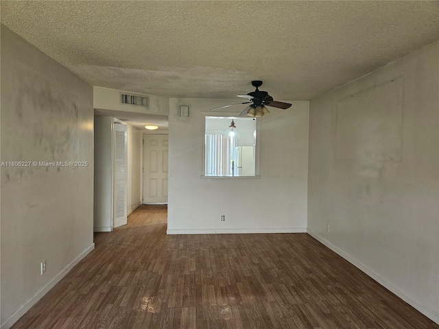 8620 N Sherman Cir Unit 202, Miramar, FL 33025 - spare room featuring dark wood-style flooring, a ceiling fan, baseboards, and a textured ceiling