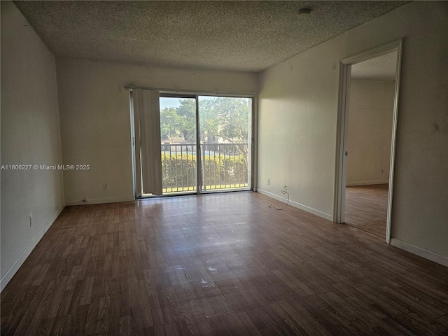 8620 N Sherman Cir Unit 202, Miramar, FL 33025 - empty room with wood finished floors, a textured ceiling, baseboards, and a smoke detector