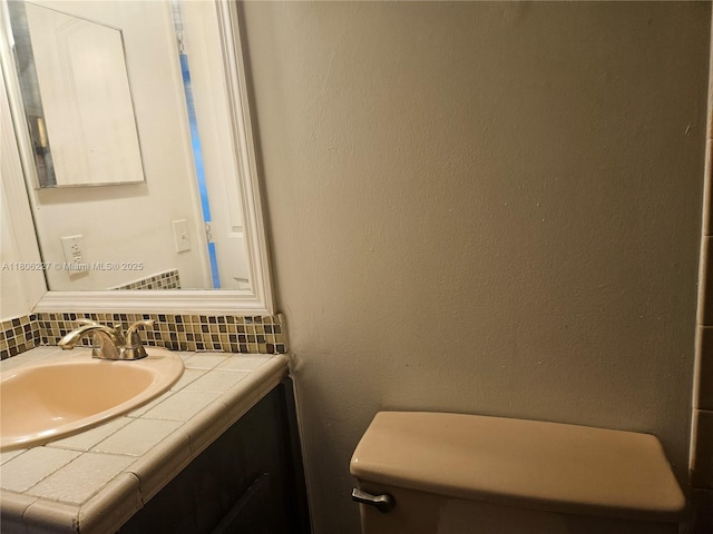 8620 N Sherman Cir Unit 202, Miramar, FL 33025 - bathroom featuring backsplash, vanity, and toilet