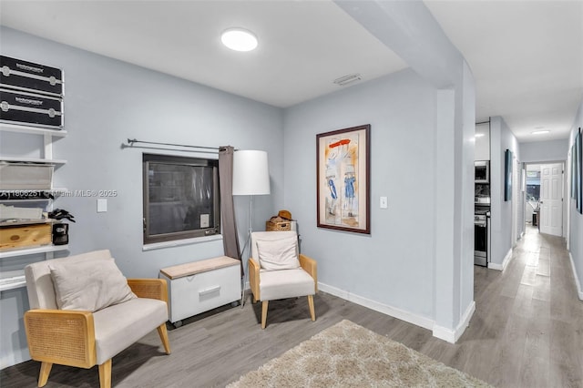 1635 NE 174th St, North Miami Beach, FL 33162 - sitting room featuring wood finished floors and baseboards