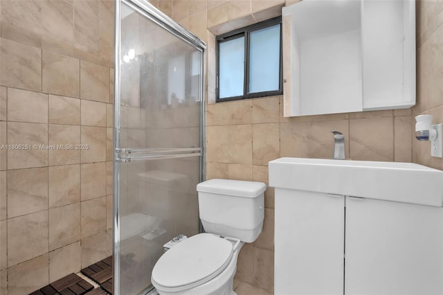 1635 NE 174th St, North Miami Beach, FL 33162 - full bathroom featuring tile walls, a shower stall, toilet, and vanity