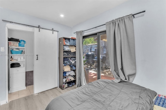 1635 NE 174th St, North Miami Beach, FL 33162 - bedroom featuring wood finished floors, a barn door, and access to exterior